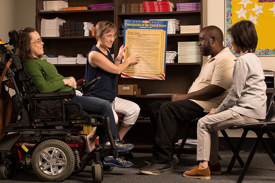 ACE Teacher Noal Weiland teaches social studies to student in wheelchair